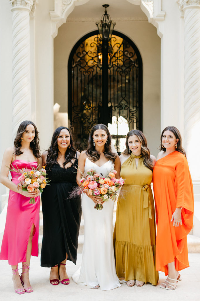 Bridesmaids wearing different dresses at wedding. Top wedding trend to watch! Mismatched dresses.